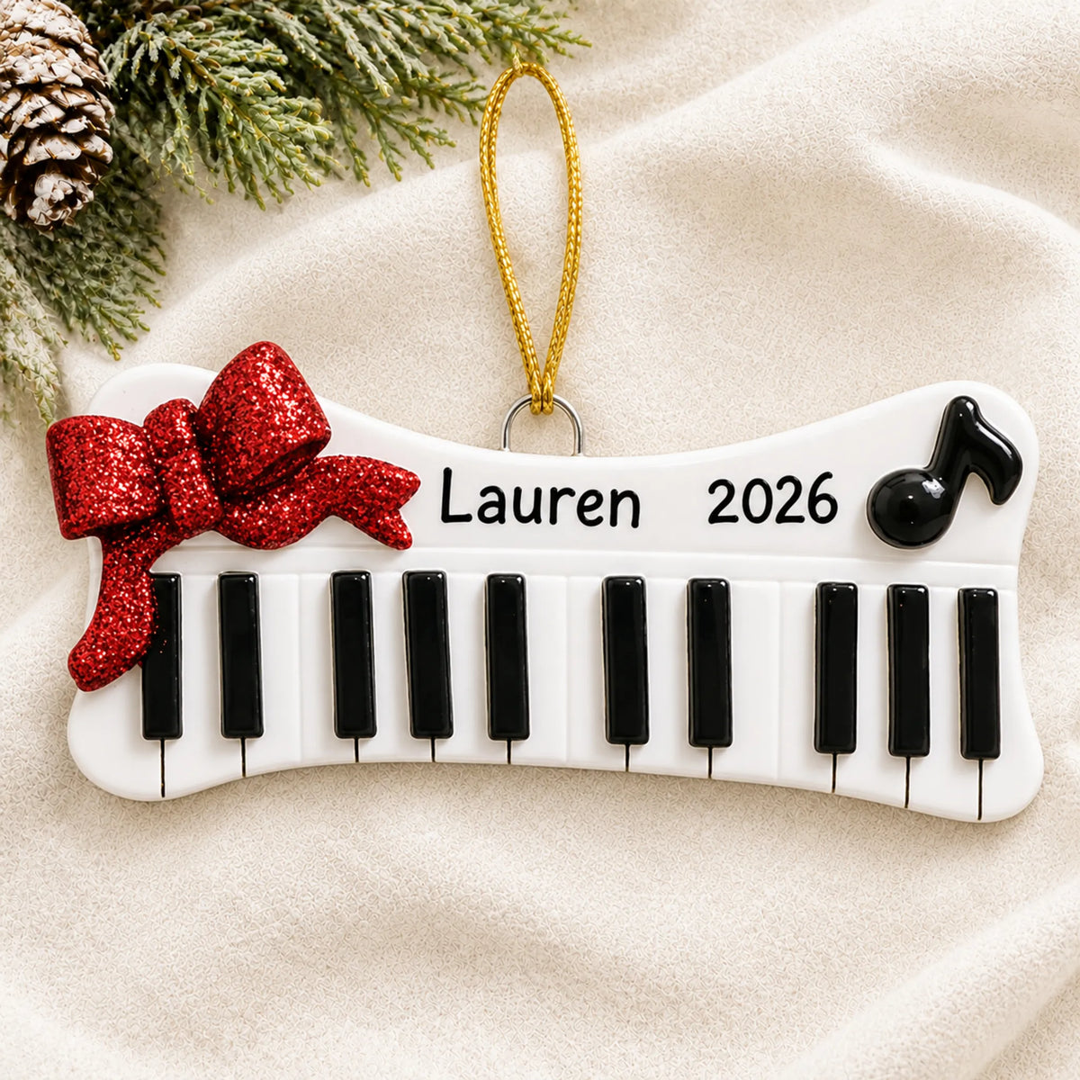 Personalized keyboard christmas ornament laid on a soft white knit blanket