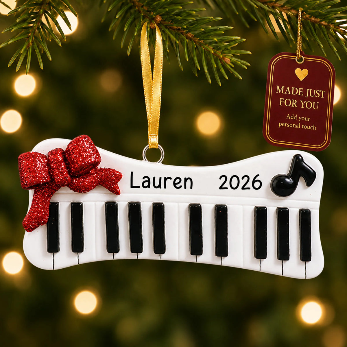 Keyboard christmas ornament hanging on a lit Christmas tree with a Made Just For You gift tag