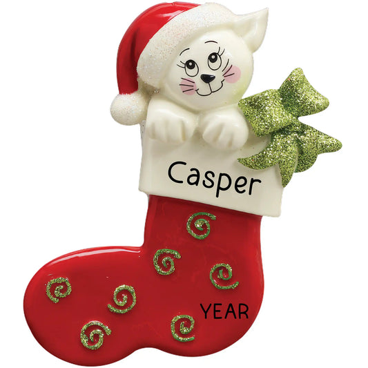 A personalized Christmas ornament featuring a white cat inside a red and white stocking, with a green bow and the name and year.