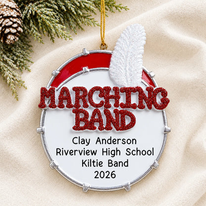 Personalized marching band christmas ornament laid on a soft white knit blanket
