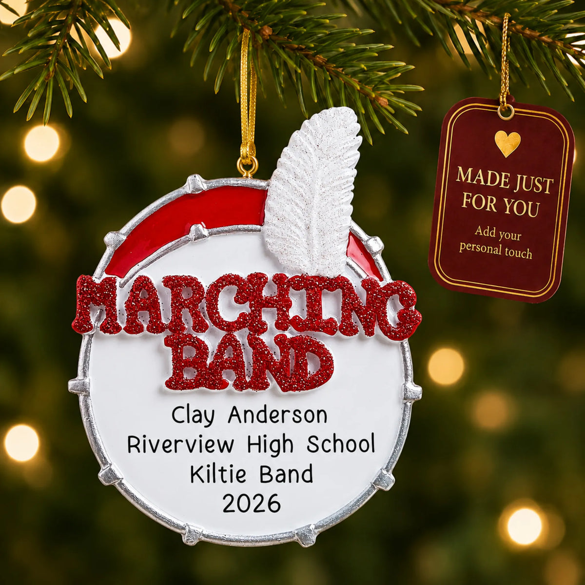 Marching band christmas ornament hanging on a lit Christmas tree with a Made Just For You gift tag