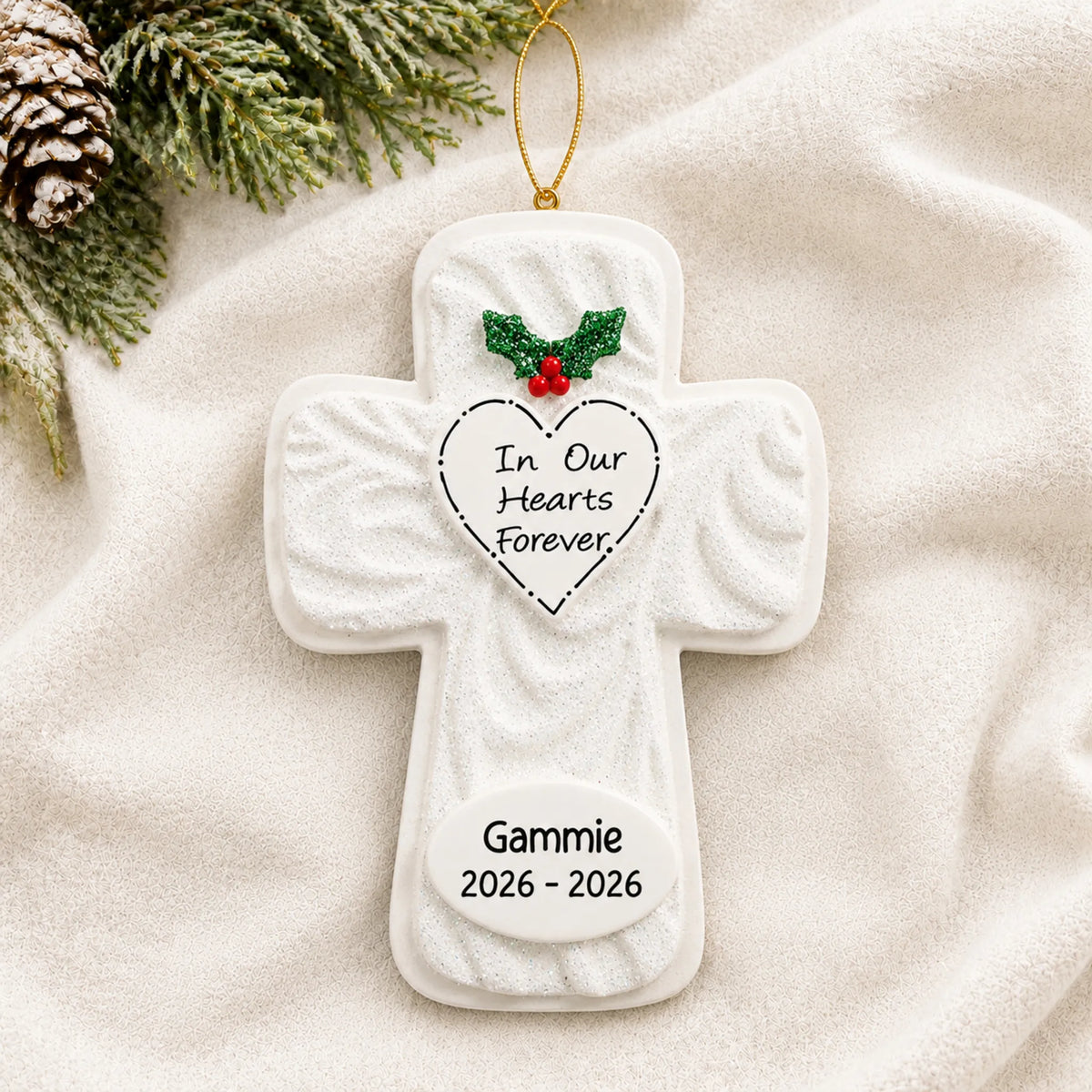Personalized Memorial Cross christmas ornament laid on a soft white knit blanket