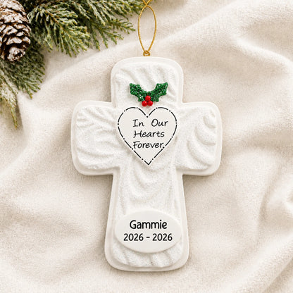 Personalized Memorial Cross christmas ornament laid on a soft white knit blanket