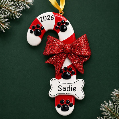 Personalized Dog Candy Cane christmas ornament on a dark green pine background