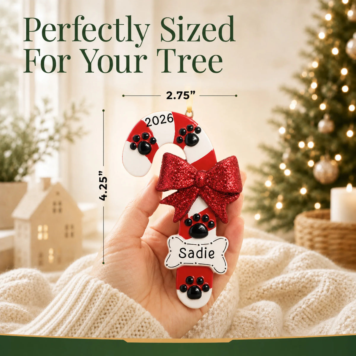 Size guide: the personalized Dog Candy Cane christmas ornament is 2.75 in wide by 4.25 in tall, shown in hand