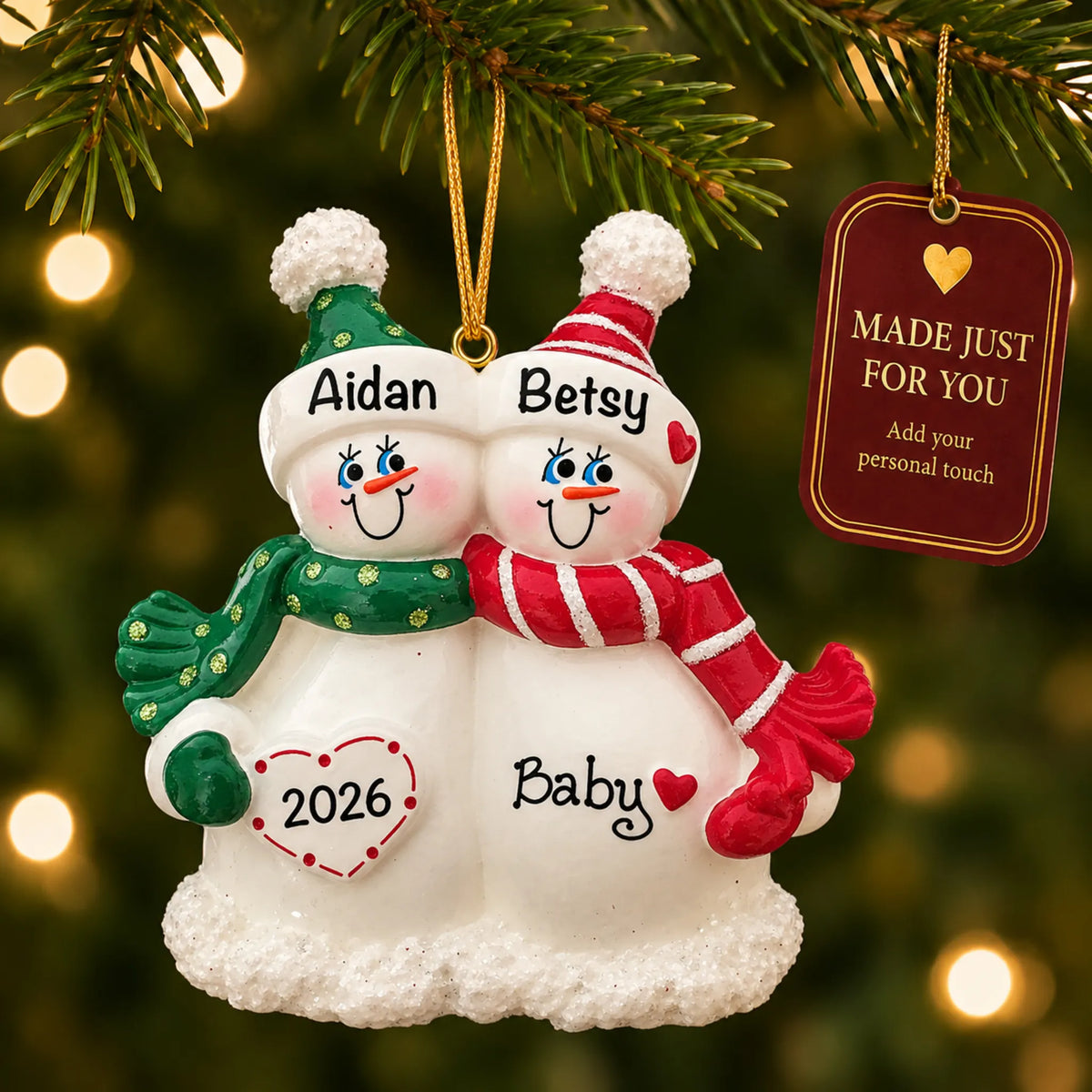 Snow Couple Expecting christmas ornament hanging on a lit Christmas tree with a Made Just For You gift tag
