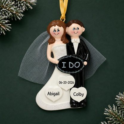 Personalized I Do wedding couple Christmas ornament with a bride and groom holding an I DO sign with names and date
