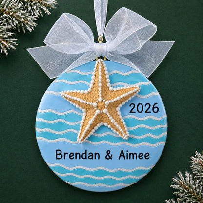 Personalized starfish beach christmas ornament on a dark green pine background