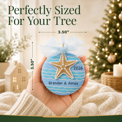 Size guide: the personalized starfish beach christmas ornament is 3.50 in wide by 3.50 in tall, shown in hand