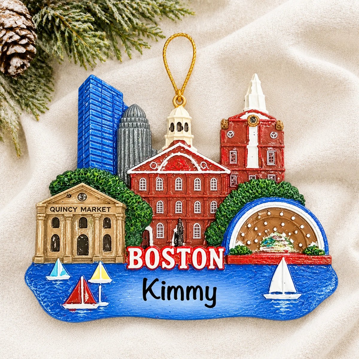 Personalized Boston christmas ornament laid on a soft white knit blanket