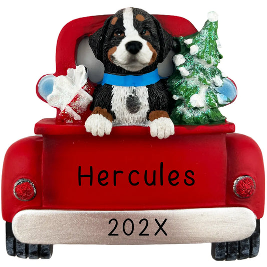 A personalized Christmas ornament featuring a Bernese Mountain Dog sitting in a red vintage truck with a name and the year printed on it.
