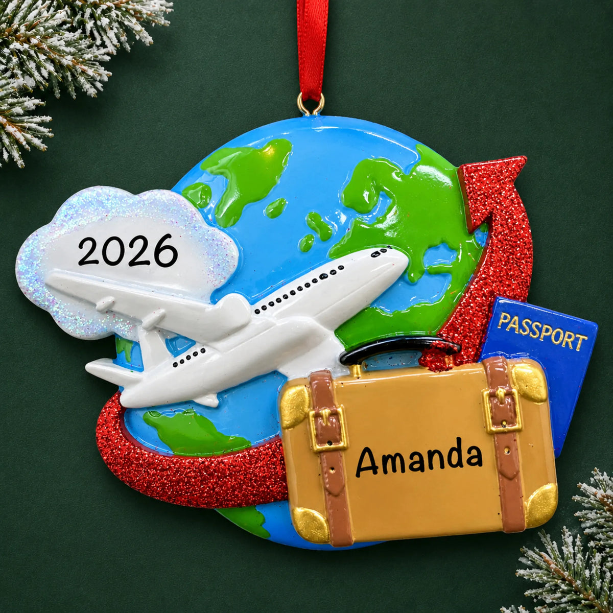 Personalized travel christmas ornament, a globe with an airplane, suitcase and passport, on a dark green pine background