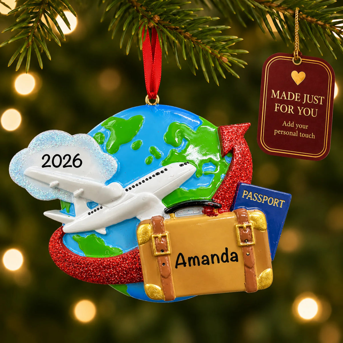 Travel christmas ornament hanging on a lit Christmas tree with a Made Just For You gift tag