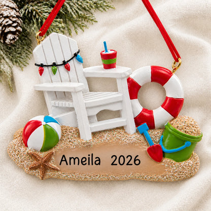 Personalized Adirondack beach chair christmas ornament laid on a soft white knit blanket