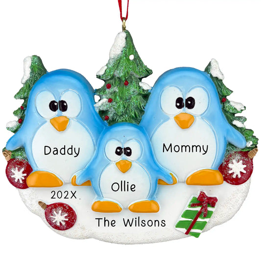 Personalized Christmas ornament of 3 penguins in front of christams trees. The names, family name and year are customizable. 
