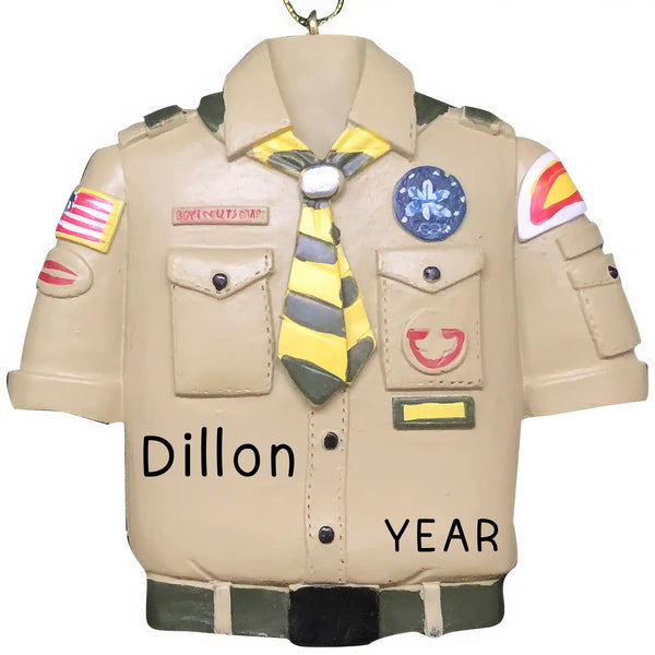 A personalized Christmas ornament designed to look like a Boy Scout in uniform, with the name 'Dillon' and the year '2021' printed on the front.
