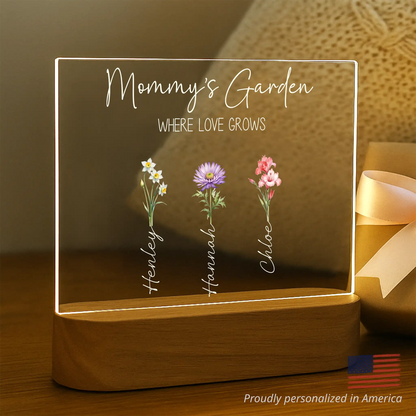 Personalized birth flower night light gifted to a smiling grandmother by her grandchildren
