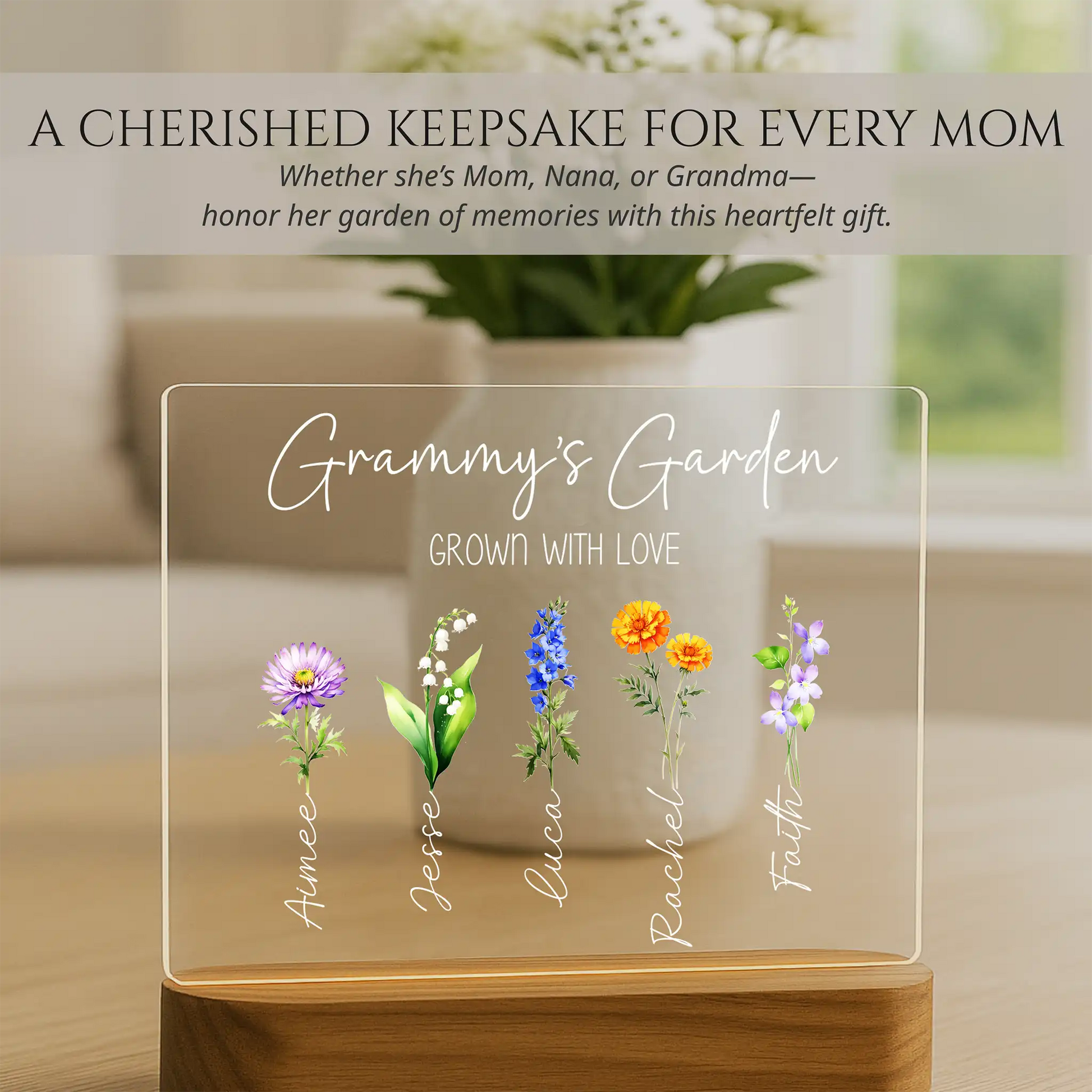 Decorative plaque with floral designs and names on a blurred indoor background