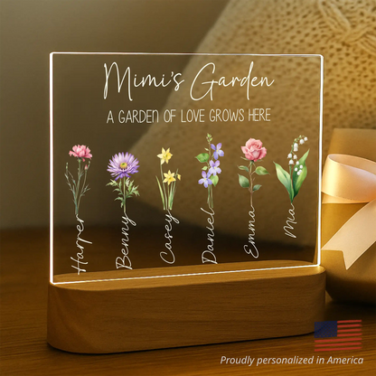 Personalized light-up sign with names of children and flowers on a wooden base.