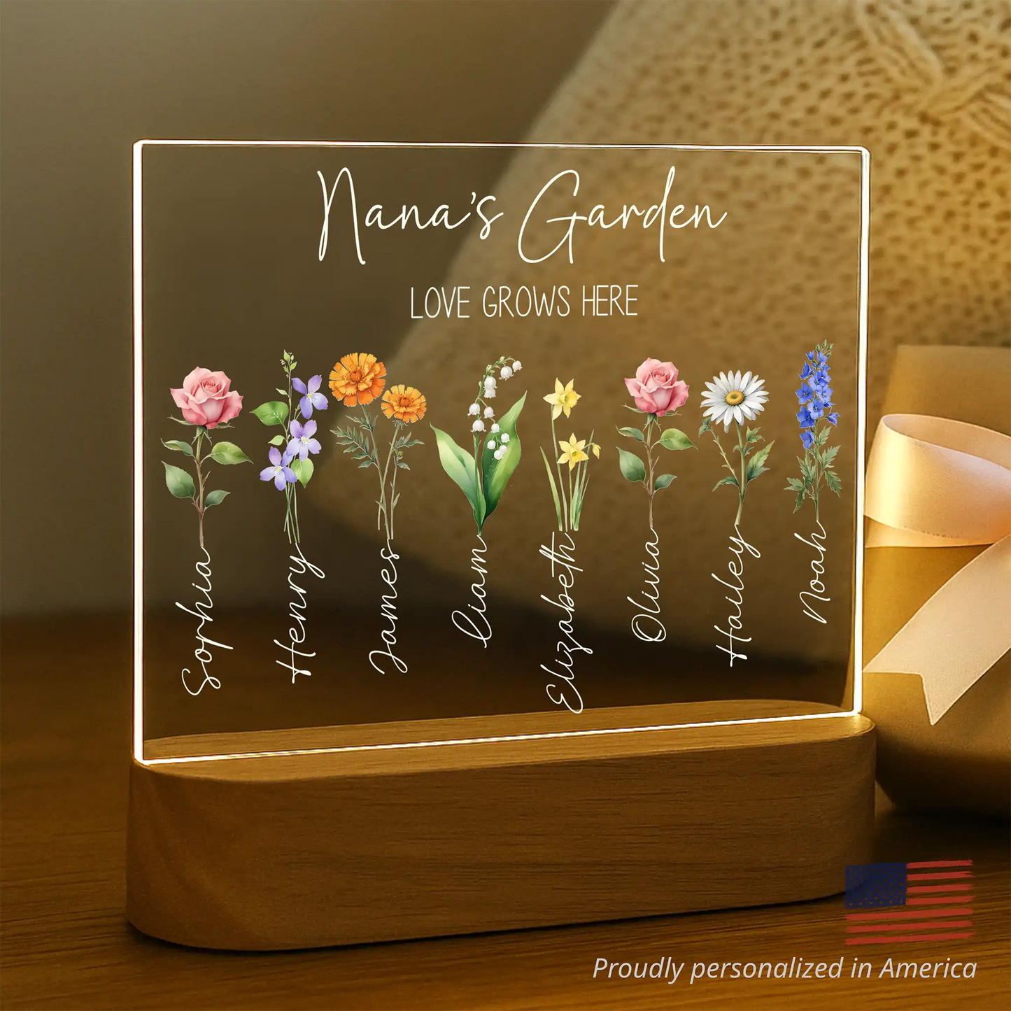 Decorative LED sign with floral illustrations and names, labeled 'Nana's Garden'.