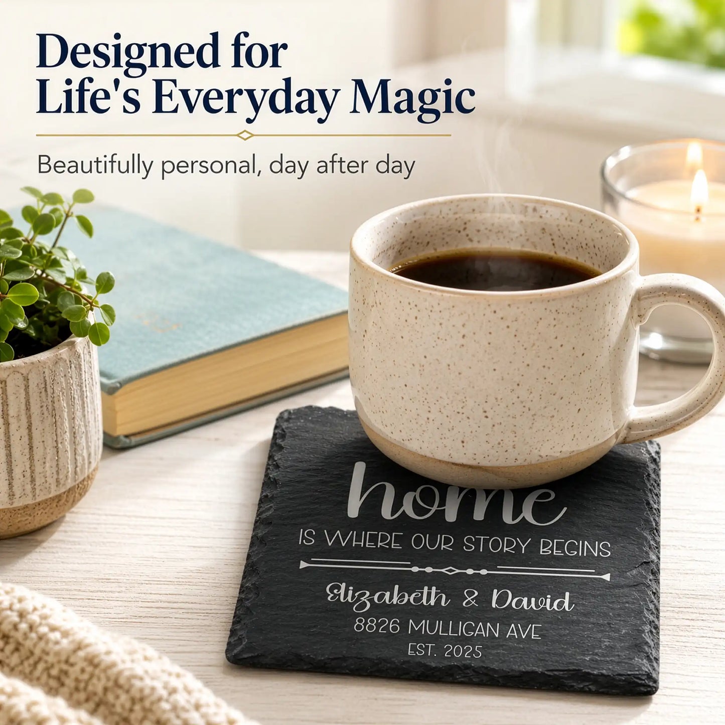 Ceramic mug with coffee on a slate coaster with personalized text, surrounded by a plant, book, and candle.
