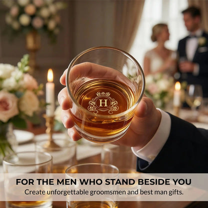 Groomsman raising a personalized whiskey glass with H monogram during a wedding reception toast