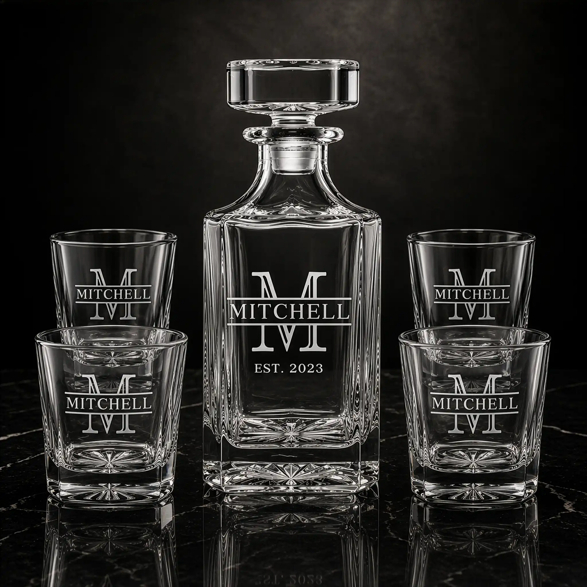 Personalized whiskey decanter and four matching rocks glasses engraved with Mitchell family name and EST. 2023 on black marble