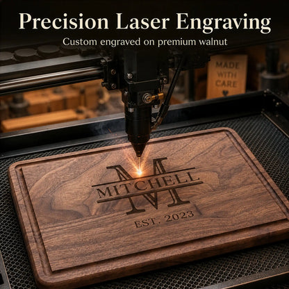 Laser engraving machine on a wooden board with engraved text 'MITCHELL' and 'EST. 2023'.