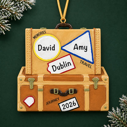 Personalized travel suitcase christmas ornament on a dark green pine background