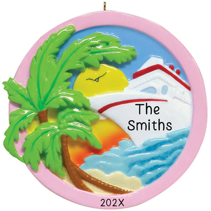 Personalized Christmas ornament depicting a white cruise ship sailing past a palm tree on a beach with a yellow sun, ready for custom engraving.