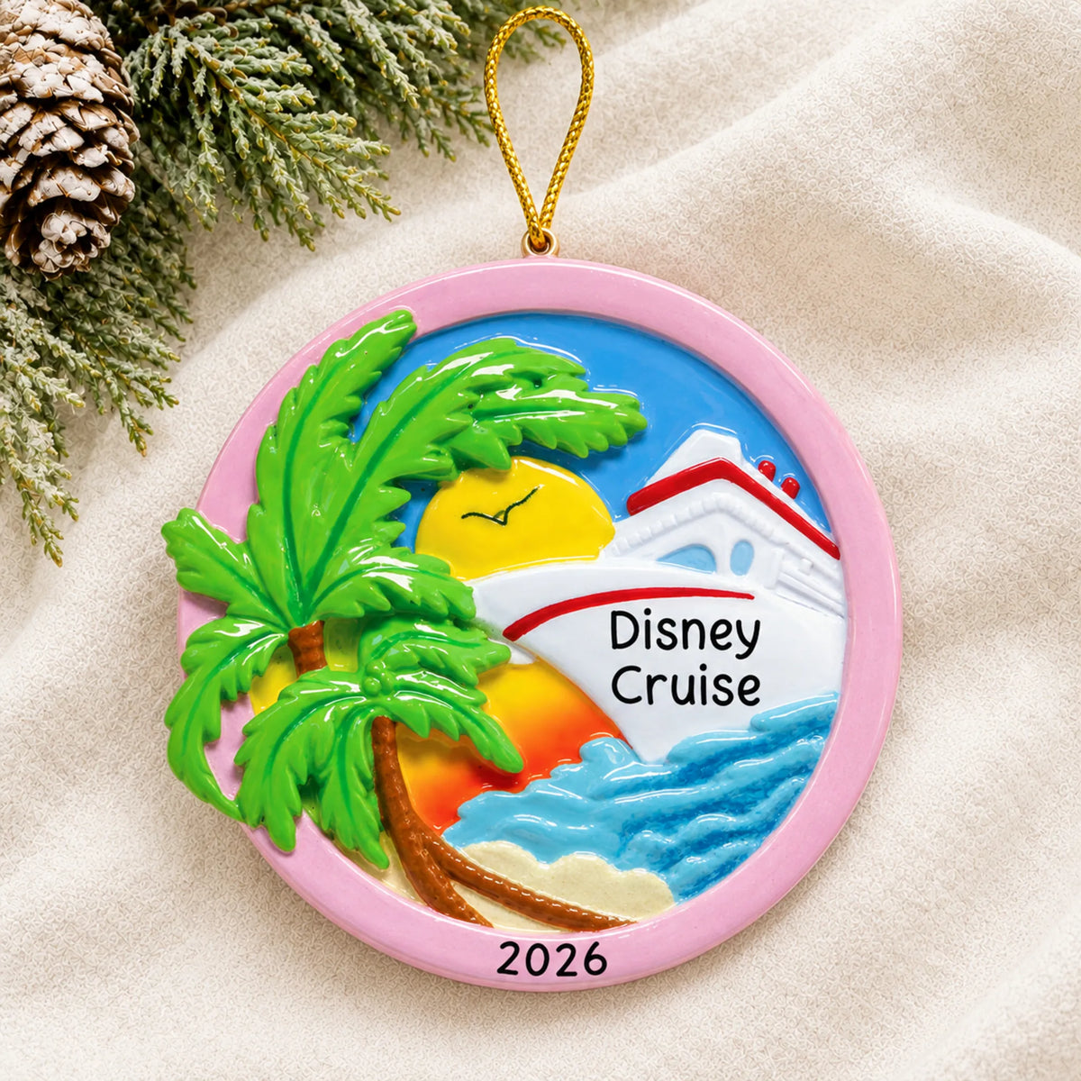 Personalized tropical cruise ship christmas ornament laid on a soft white knit blanket
