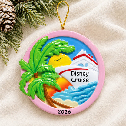 Personalized tropical cruise ship christmas ornament laid on a soft white knit blanket