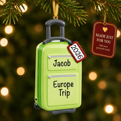 Green travel suitcase christmas ornament hanging on a lit Christmas tree with a Made Just For You gift tag