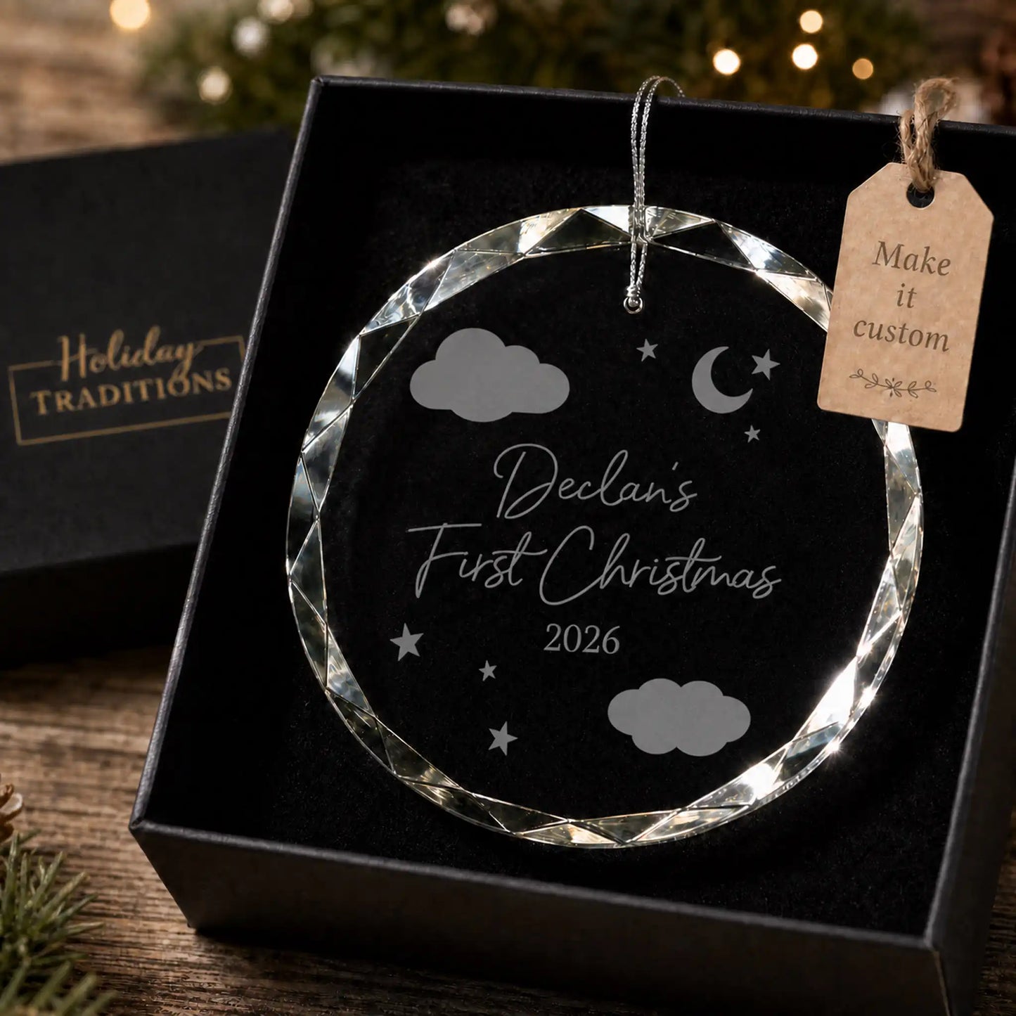 Baby's first Christmas personalized glass ornament with clouds, moon and stars, laser engraved with baby's name and year, shown in its black gift box