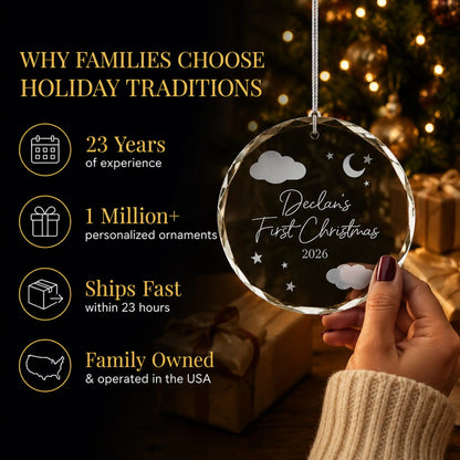 Hand holding the personalized baby's first Christmas glass ornament by the tree, Holiday Traditions is family owned in the USA and ships within 23 hours