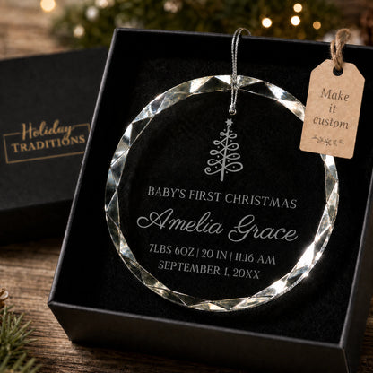 Baby's first Christmas personalized glass ornament with a Christmas tree design, laser engraved with baby's name and birth stats, shown in its black gift box