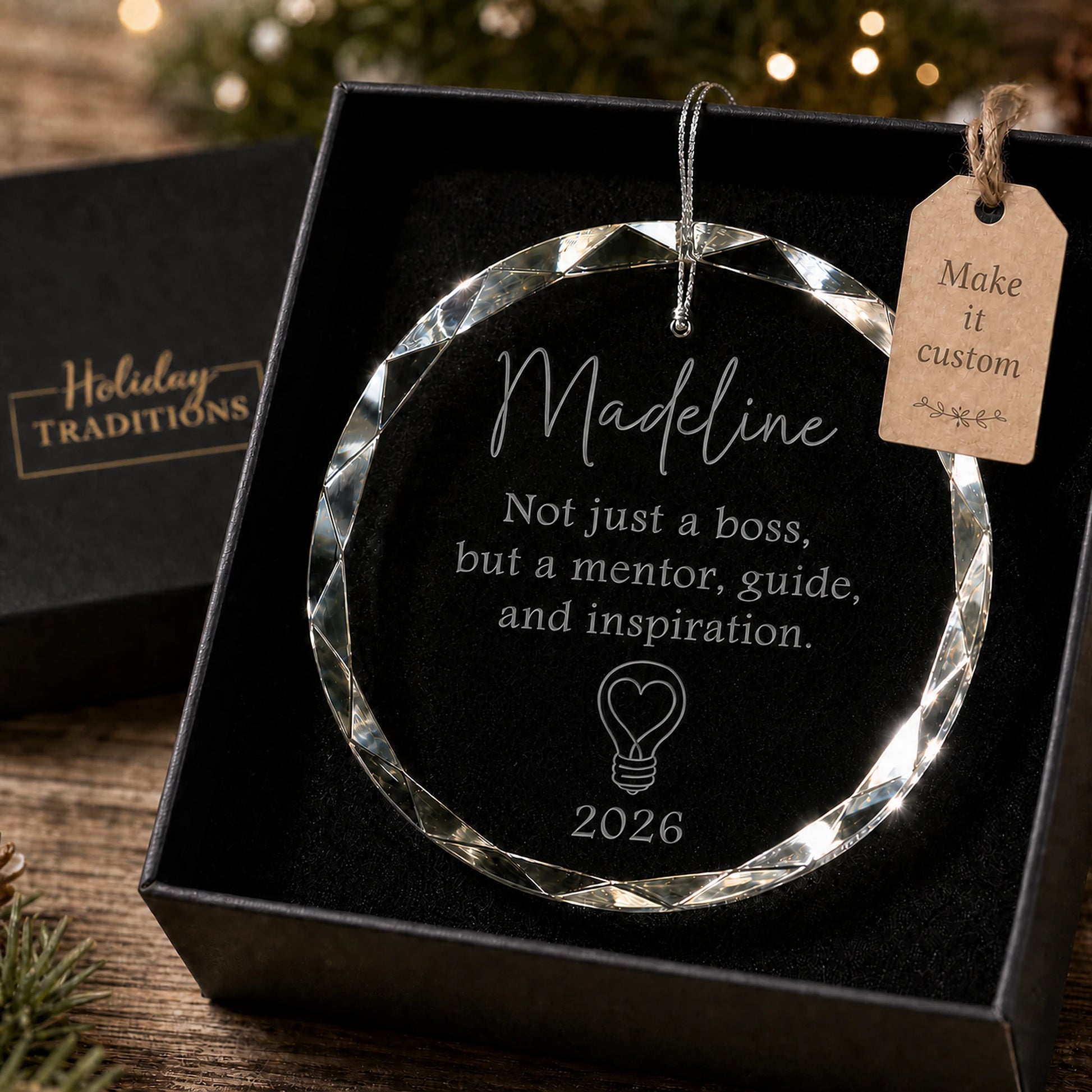Mentor and inspiration boss personalized glass ornament with a heart lightbulb, laser engraved with the boss's name and year, shown in its black gift box