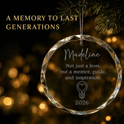 Personalized mentor boss glass Christmas ornament in K9 optical glass hanging on a lit tree, engraved with Not just a boss but a mentor, guide and inspiration, name and year