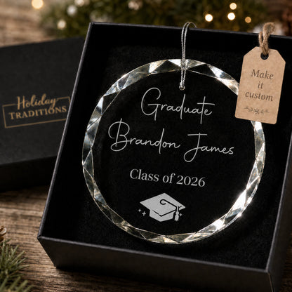 Graduate personalized glass ornament, laser engraved with Graduate, the graduate's name and class year with a graduation cap, shown in its black gift box