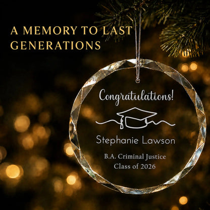 Congratulations personalized graduation Christmas ornament in K9 optical glass hanging on a lit tree, engraved with the graduate's name, degree and class year