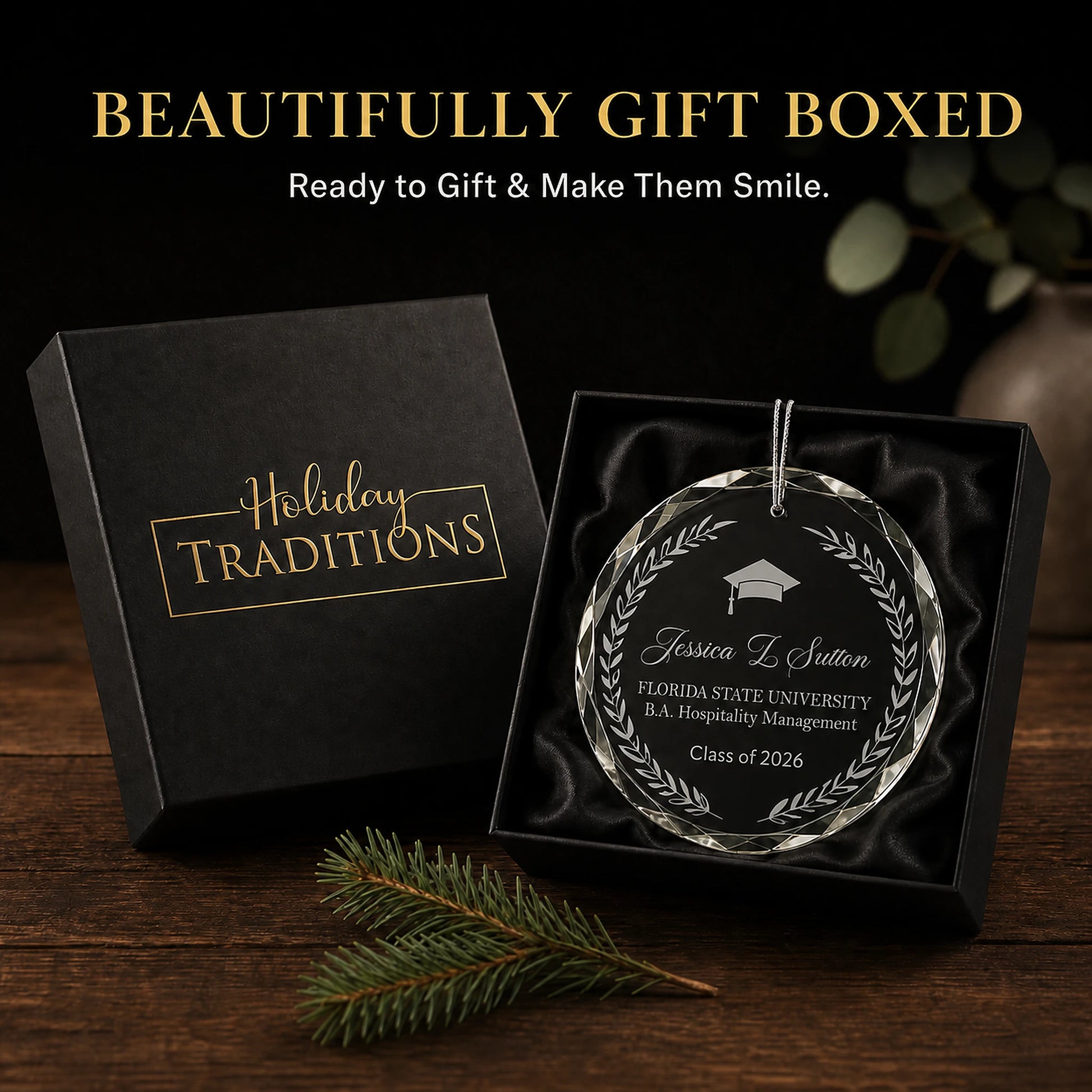 Laurel wreath personalized graduation glass ornament arrives in a black Holiday Traditions gift box, ready to give