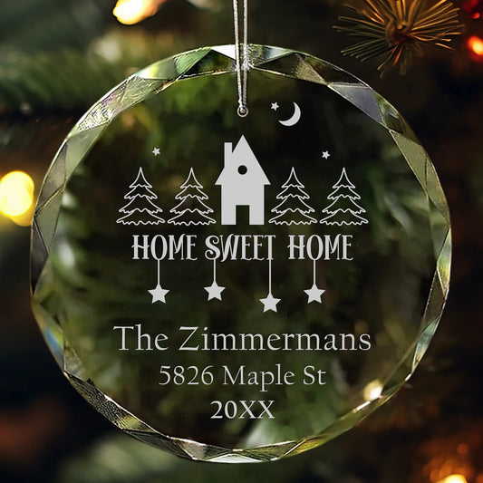 Personalized glass ornament engraved with “Home Sweet Home,” house and tree design, and family name.