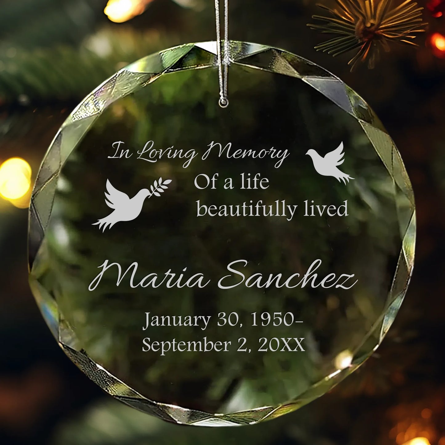 Personalized crystal memorial ornament engraved with name, dates, and doves.