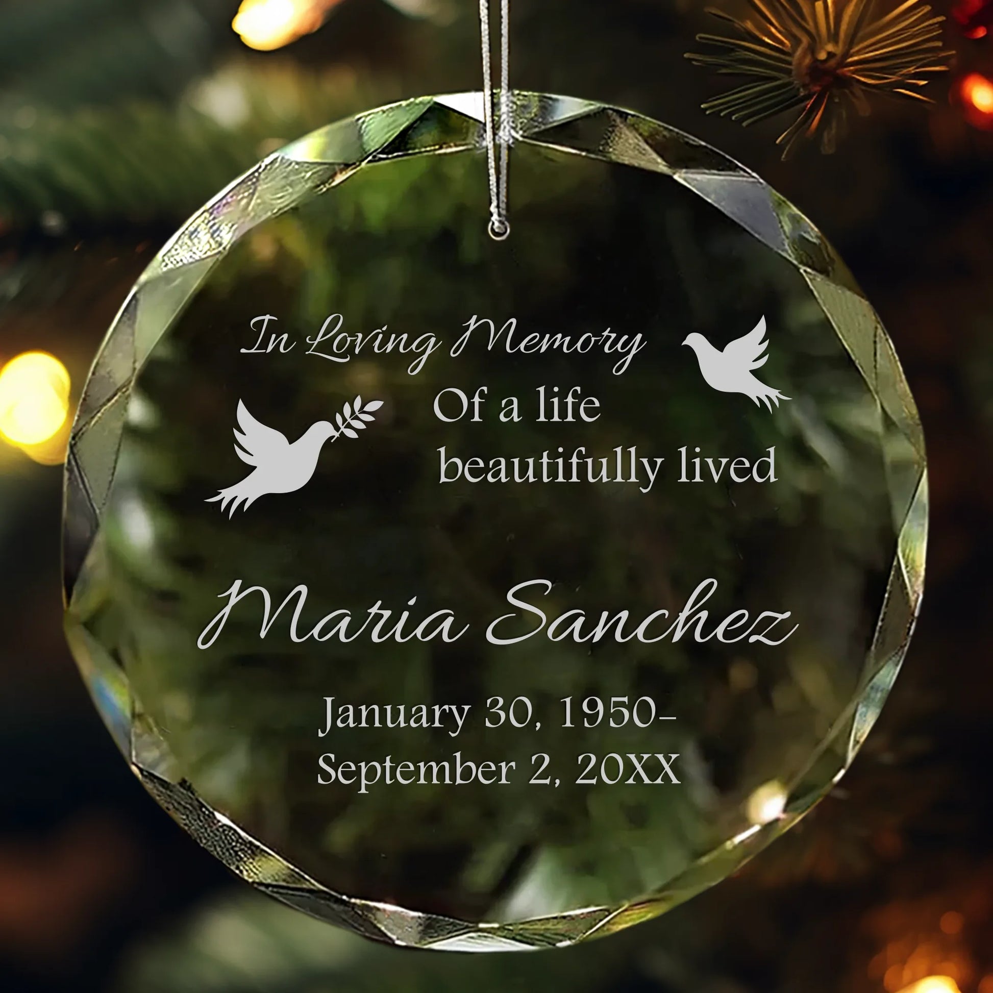 Personalized crystal memorial ornament engraved with name, dates, and doves.