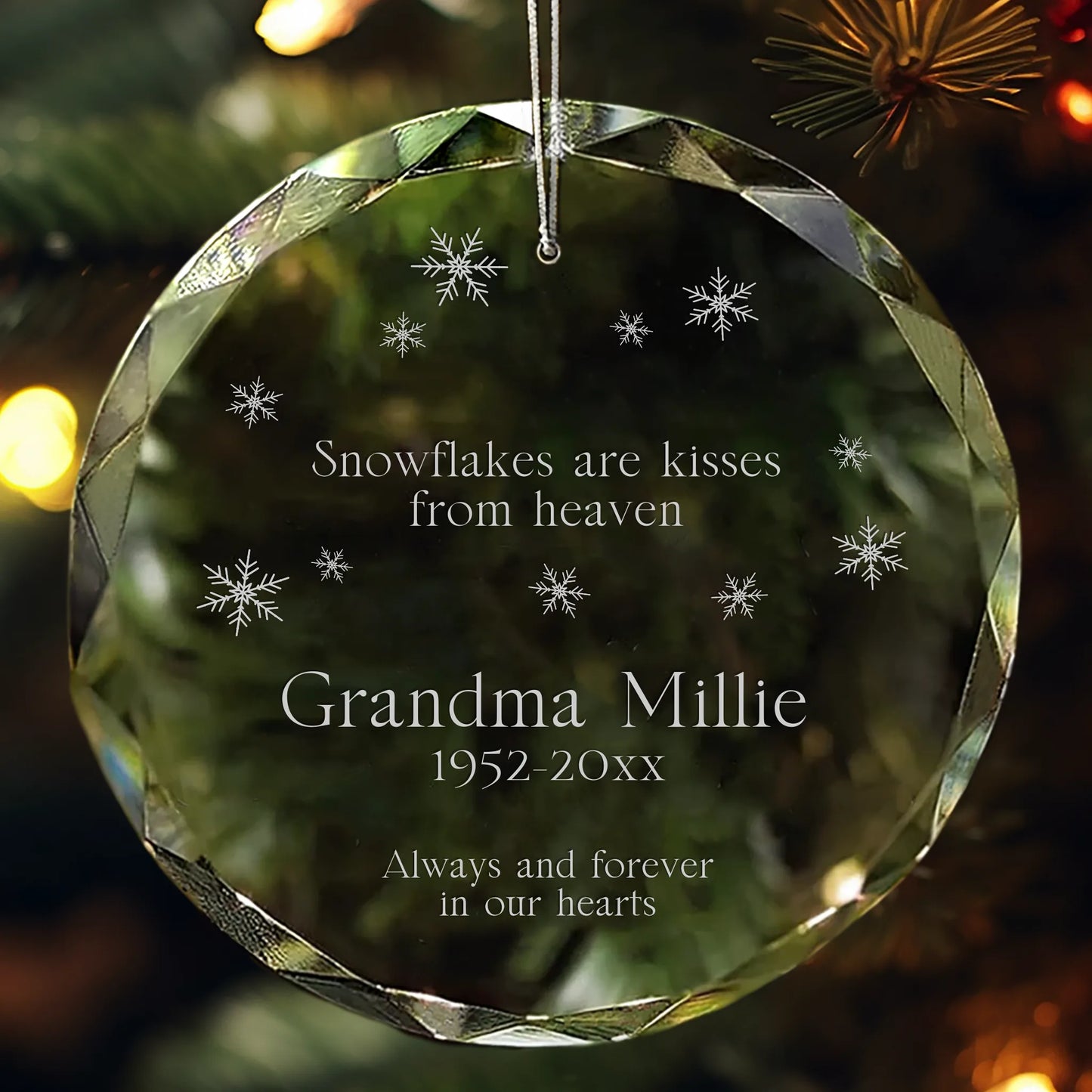 Personalized glass ornament engraved with “Snowflakes are kisses from heaven” and snowflake designs