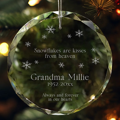 Personalized glass ornament engraved with “Snowflakes are kisses from heaven” and snowflake designs