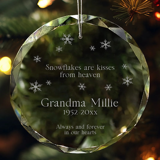 Personalized glass ornament engraved with “Snowflakes are kisses from heaven” and snowflake designs