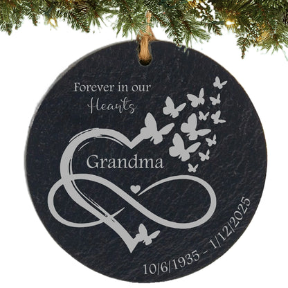 Slate ornament engraved with “Forever in Our Hearts,” an infinity heart with butterflies, name, and memorial dates.