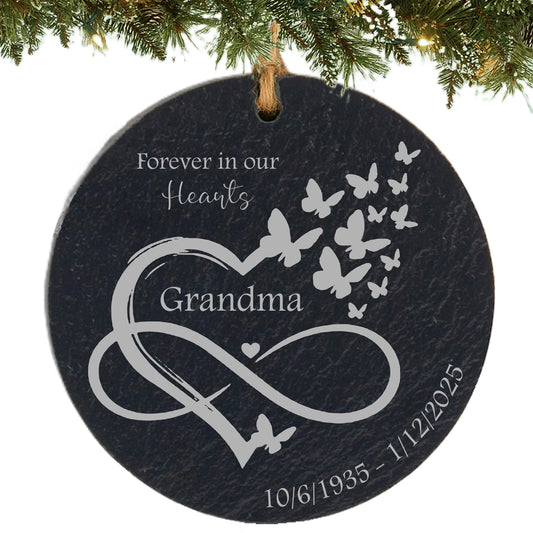 Slate ornament engraved with “Forever in Our Hearts,” an infinity heart with butterflies, name, and memorial dates.