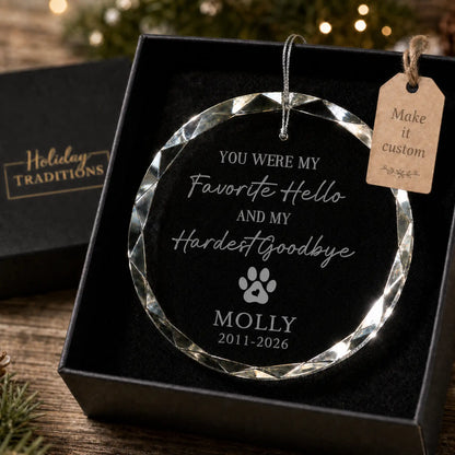 Favorite Hello Hardest Goodbye pet memorial personalized glass ornament with a paw print and heart, laser engraved with the pet's name and memorial dates, shown in its black gift box